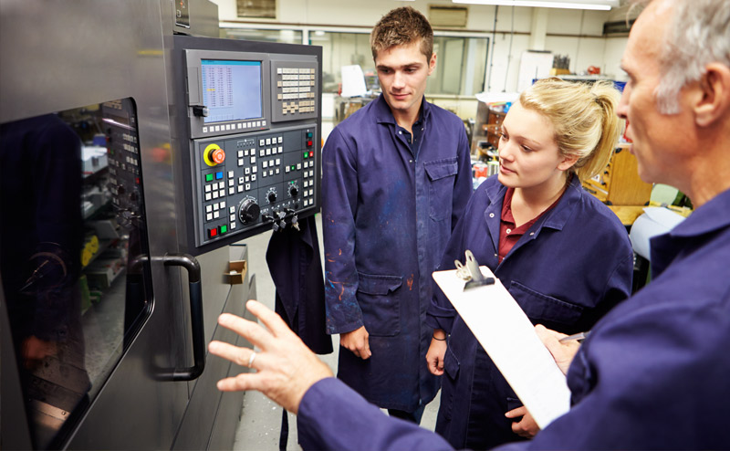 Engineers learning about PLCs and HMIs