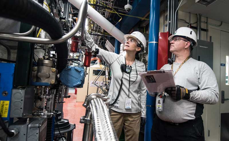 Engineers assessing component conditions