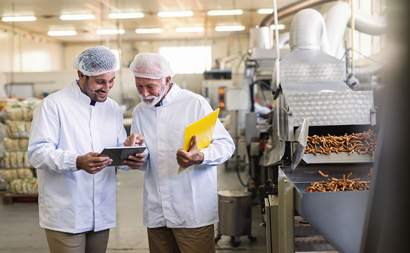 Workers in a food facility not wearing ear defenders